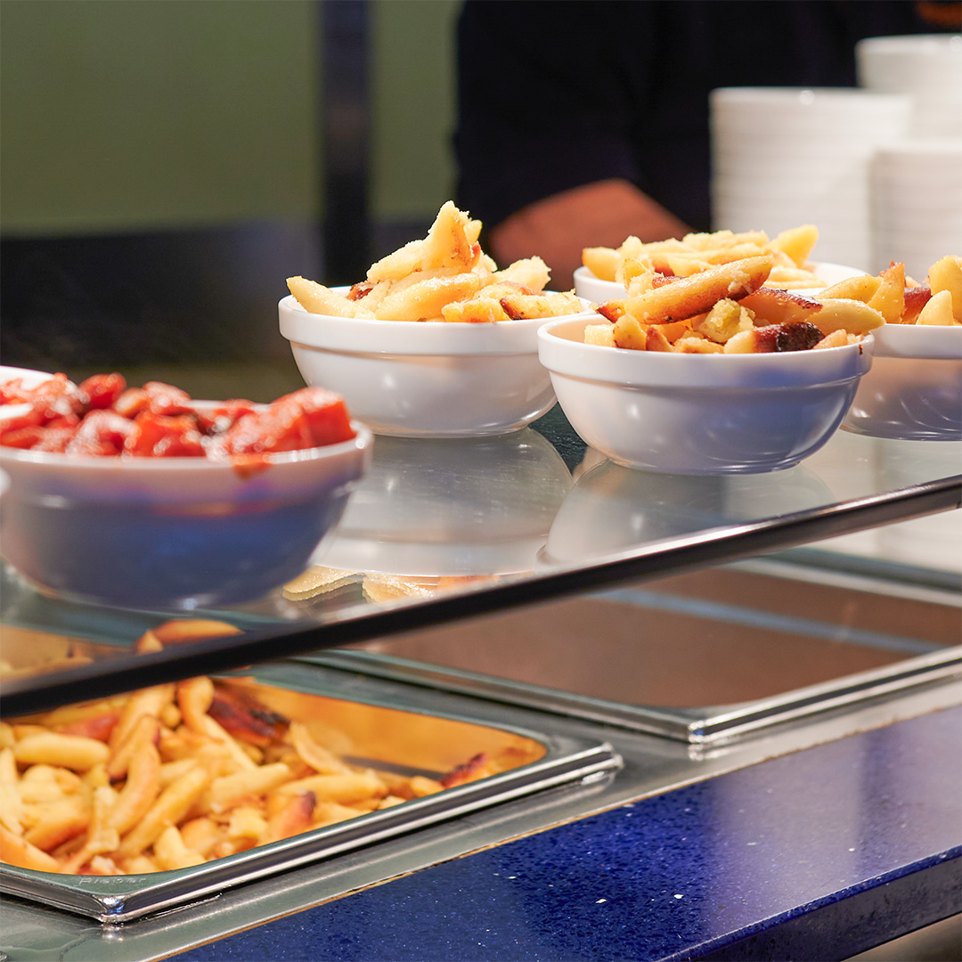 Beilagenschälchen mit Schupfnudeln auf der Ausgabetheke.
