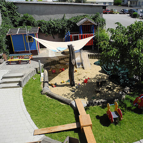 Child-orientated outdoor area with seesaws, sandboxes and plenty of space for toddlers to play